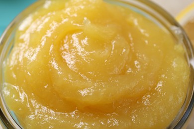 Photo of Delicious lemon curd in glass jar, closeup