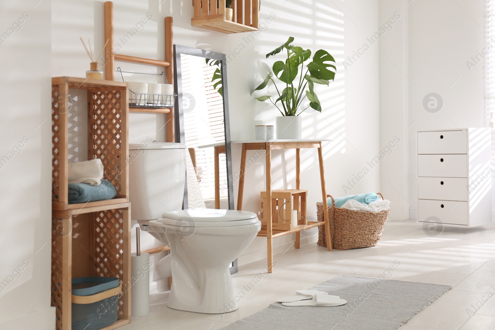 Photo of Interior of stylish bathroom with toilet bowl and decor elements