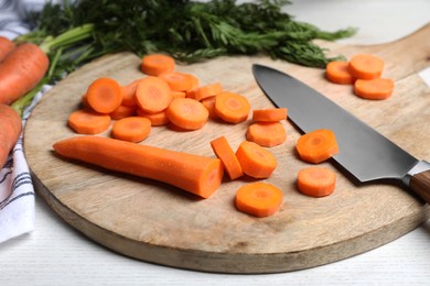Photo of Sliced fresh ripe juicy carrots on white table