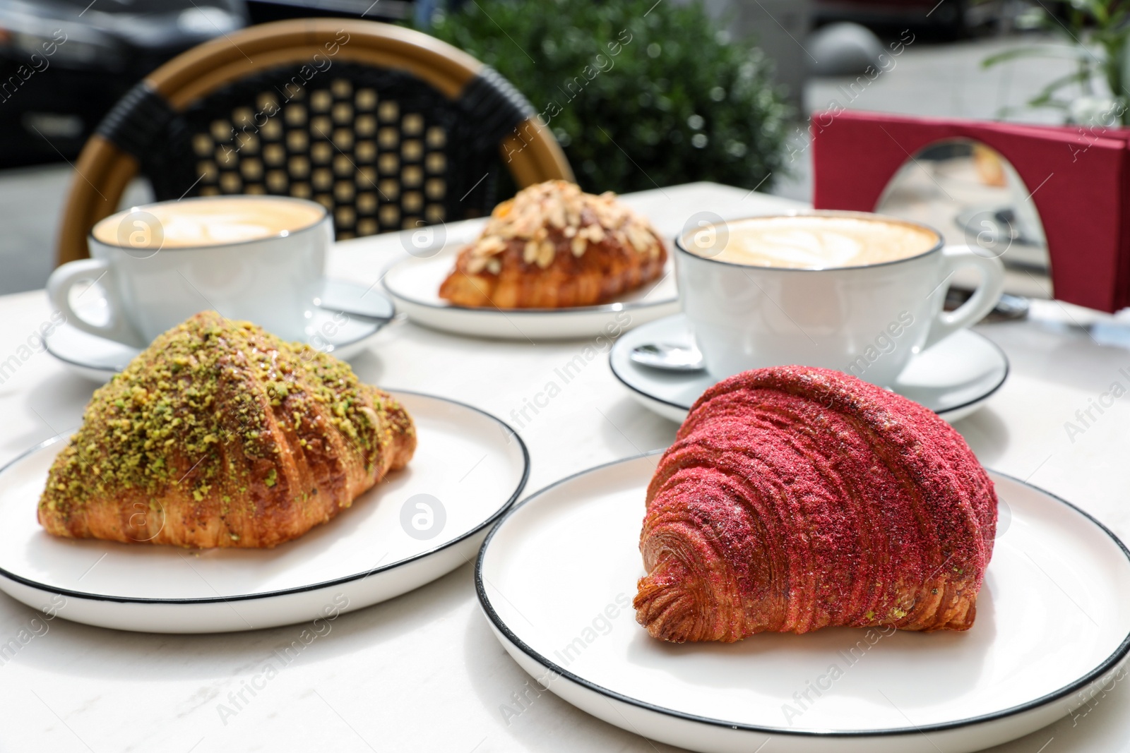 Photo of Delicious croissants and coffee on white marble table