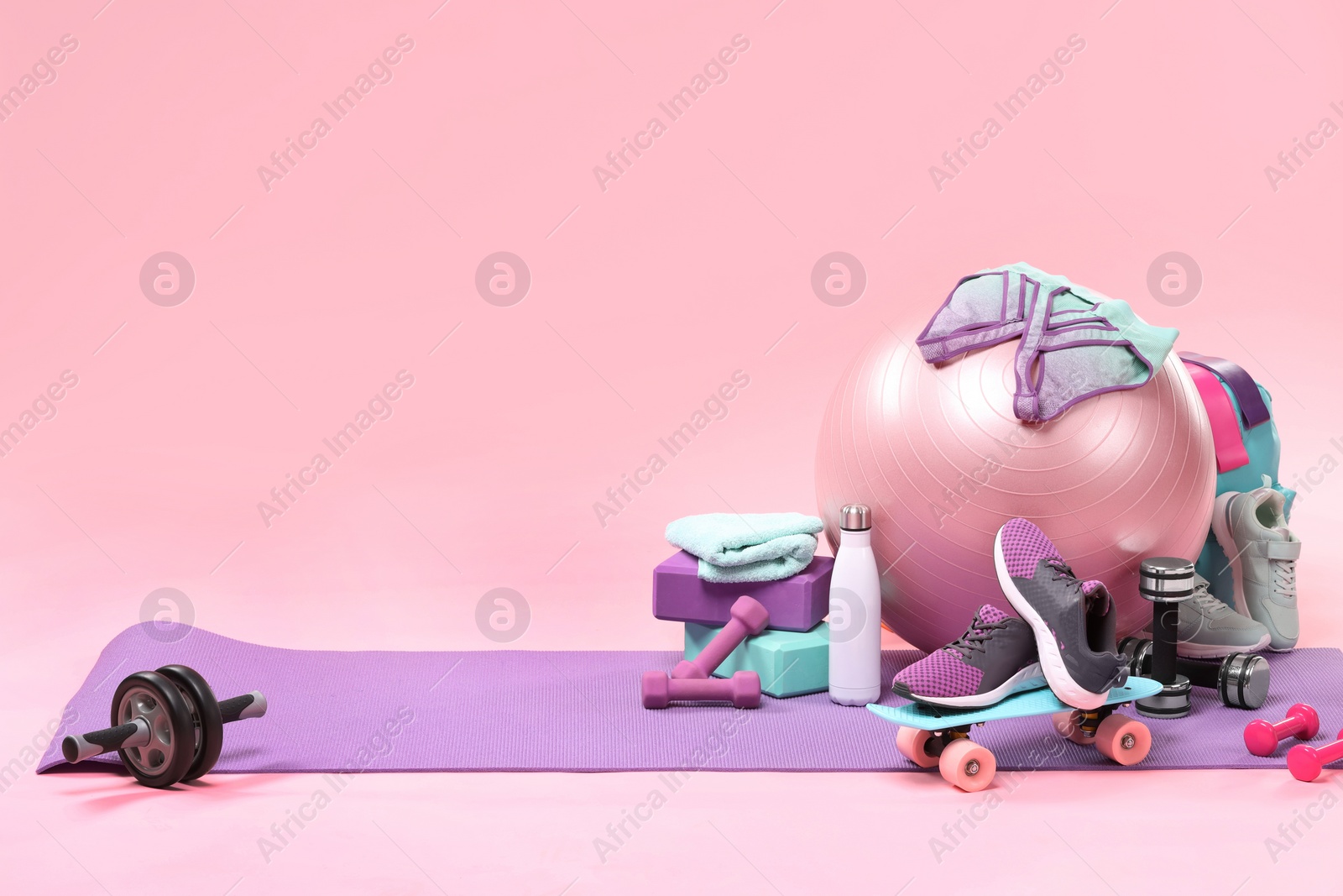 Photo of Many different sports equipment on pink background, space for text