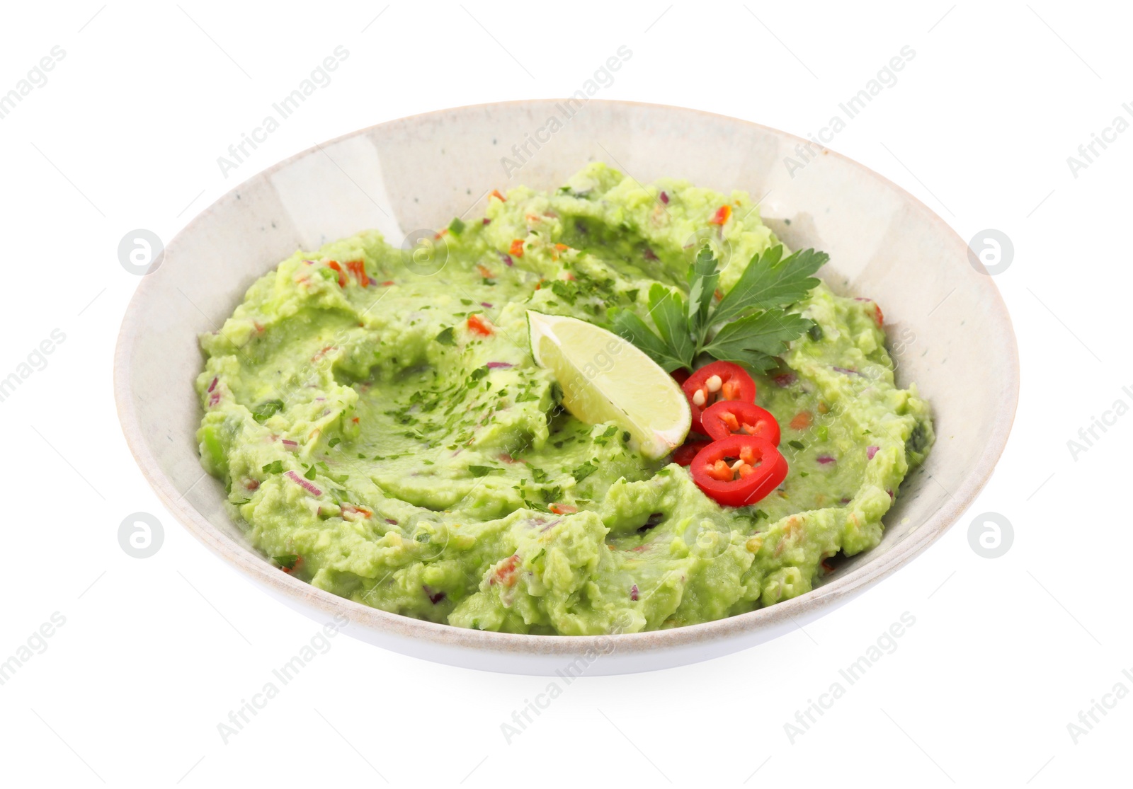 Photo of Delicious guacamole served with lime, pepper and parsley isolated on white
