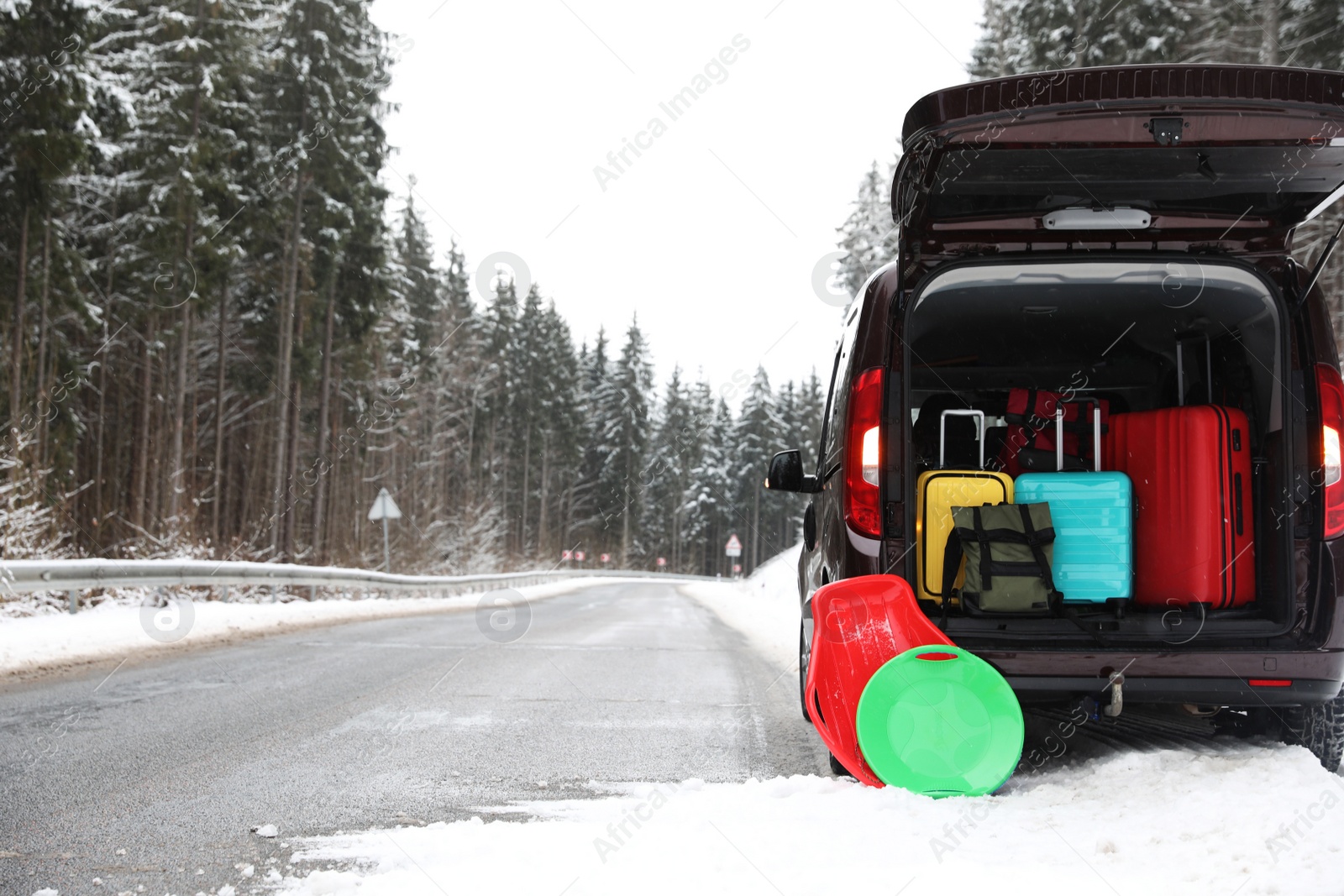 Photo of Car with open trunk full of luggage near road, space for text. Winter vacation