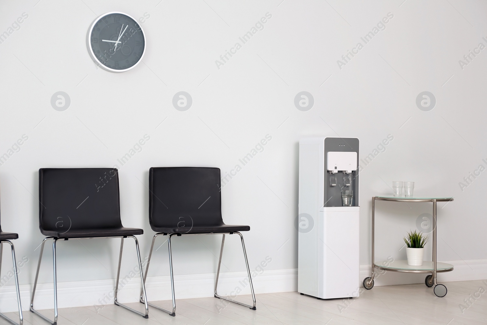 Photo of Modern water cooler in stylish office interior