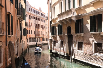 VENICE, ITALY - JUNE 13, 2019: City canal with old buildings and boats