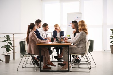 Photo of Businesspeople having meeting in office. Management consulting
