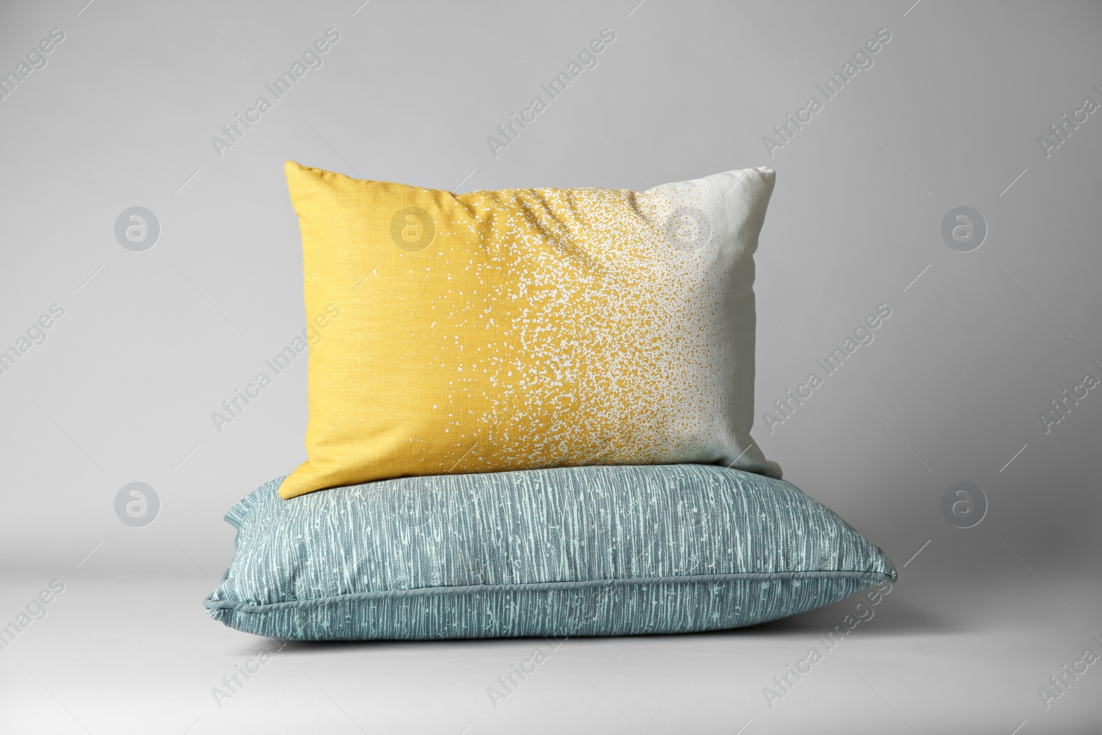 Photo of Soft decorative pillows on light background