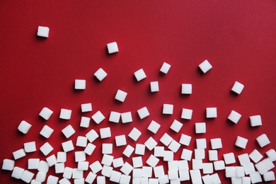 Refined sugar cubes on color background, top view