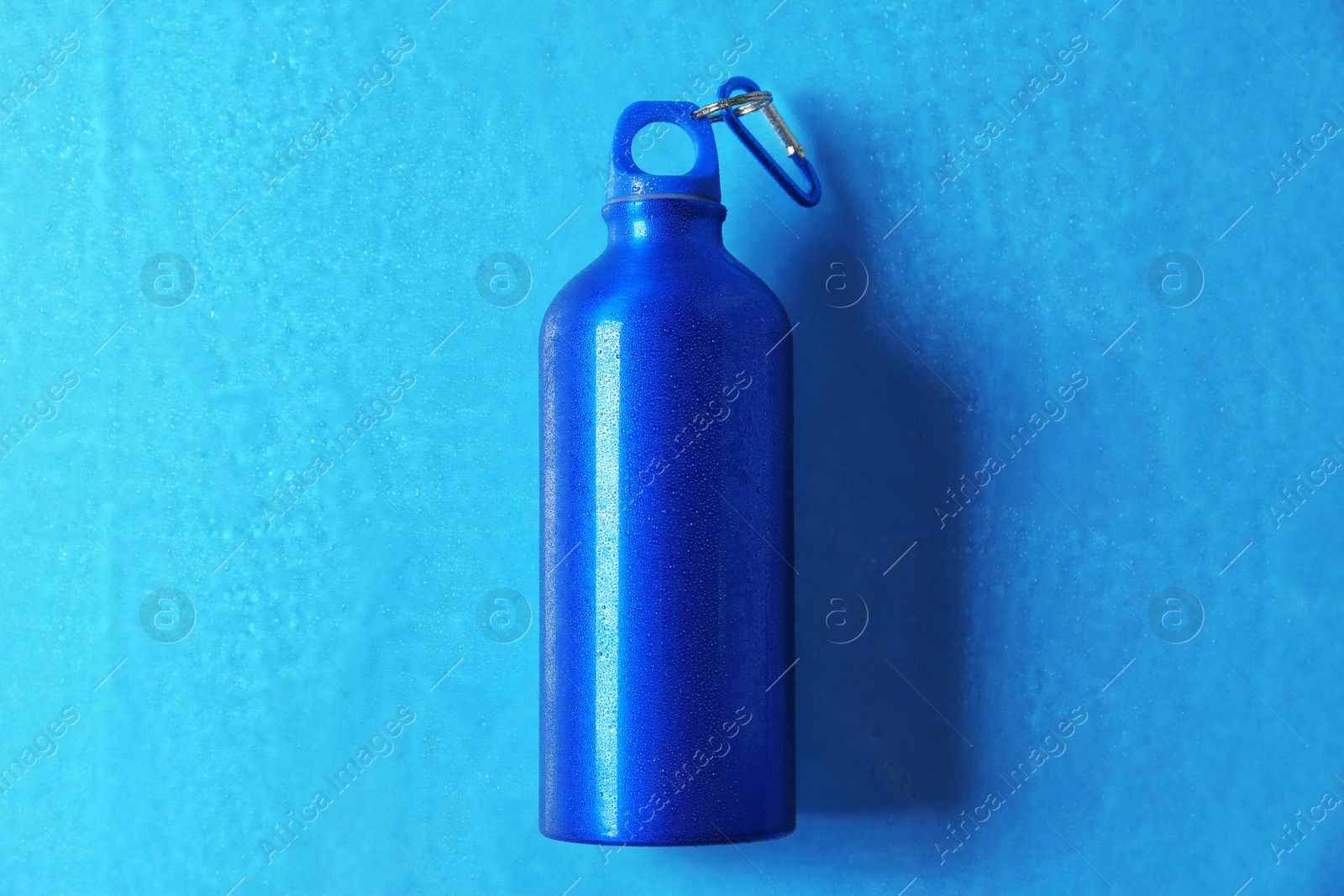 Photo of Aluminum sports water bottle on color background