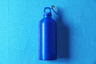 Aluminum sports water bottle on color background