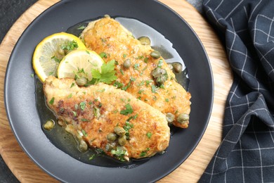 Delicious chicken piccata on table, top view