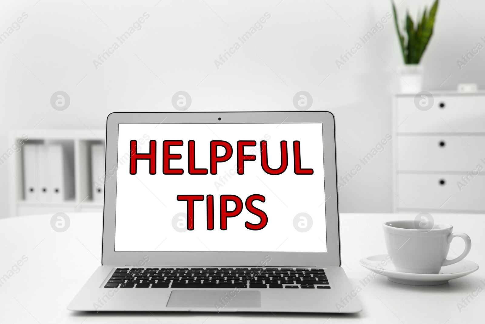 Image of Modern laptop with phrase Helpful Tips on screen indoors