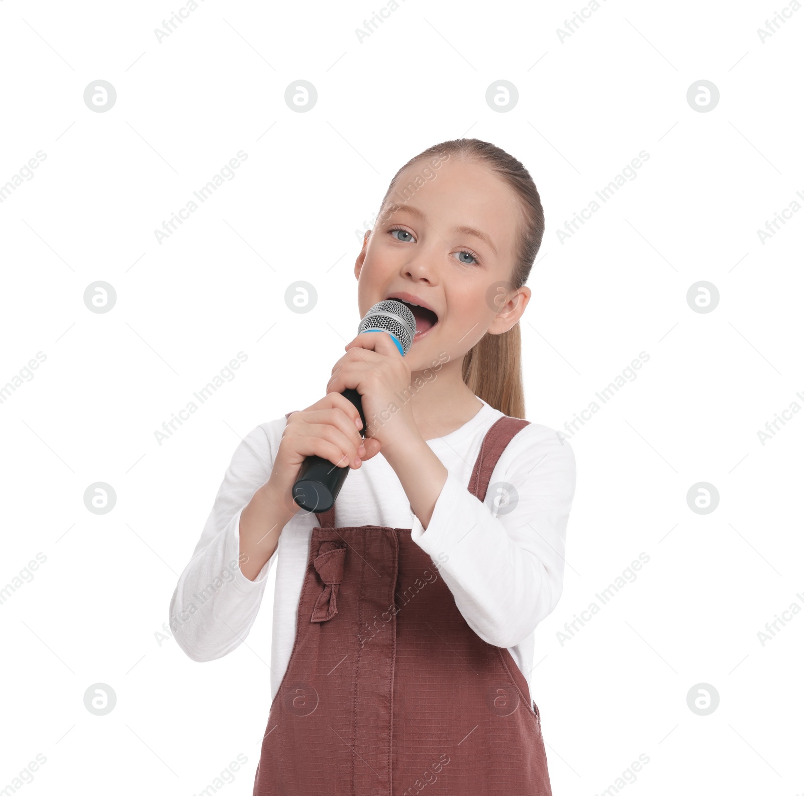 Photo of Cute little girl with microphone singing on white background