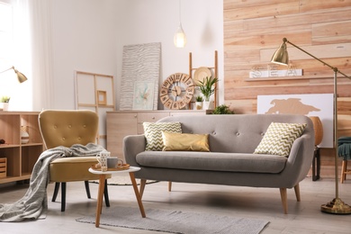 Photo of Stylish living room interior with comfortable sofa. Idea for home decor