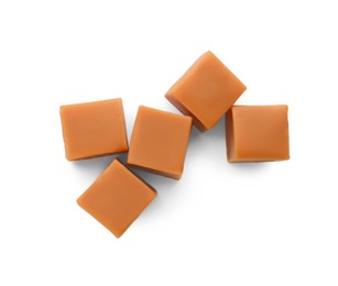 Photo of Heap of caramel candies on white background, top view