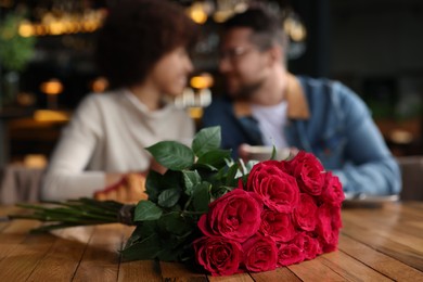 Photo of International dating. Happy couple spending time together in restaurant, selective focus