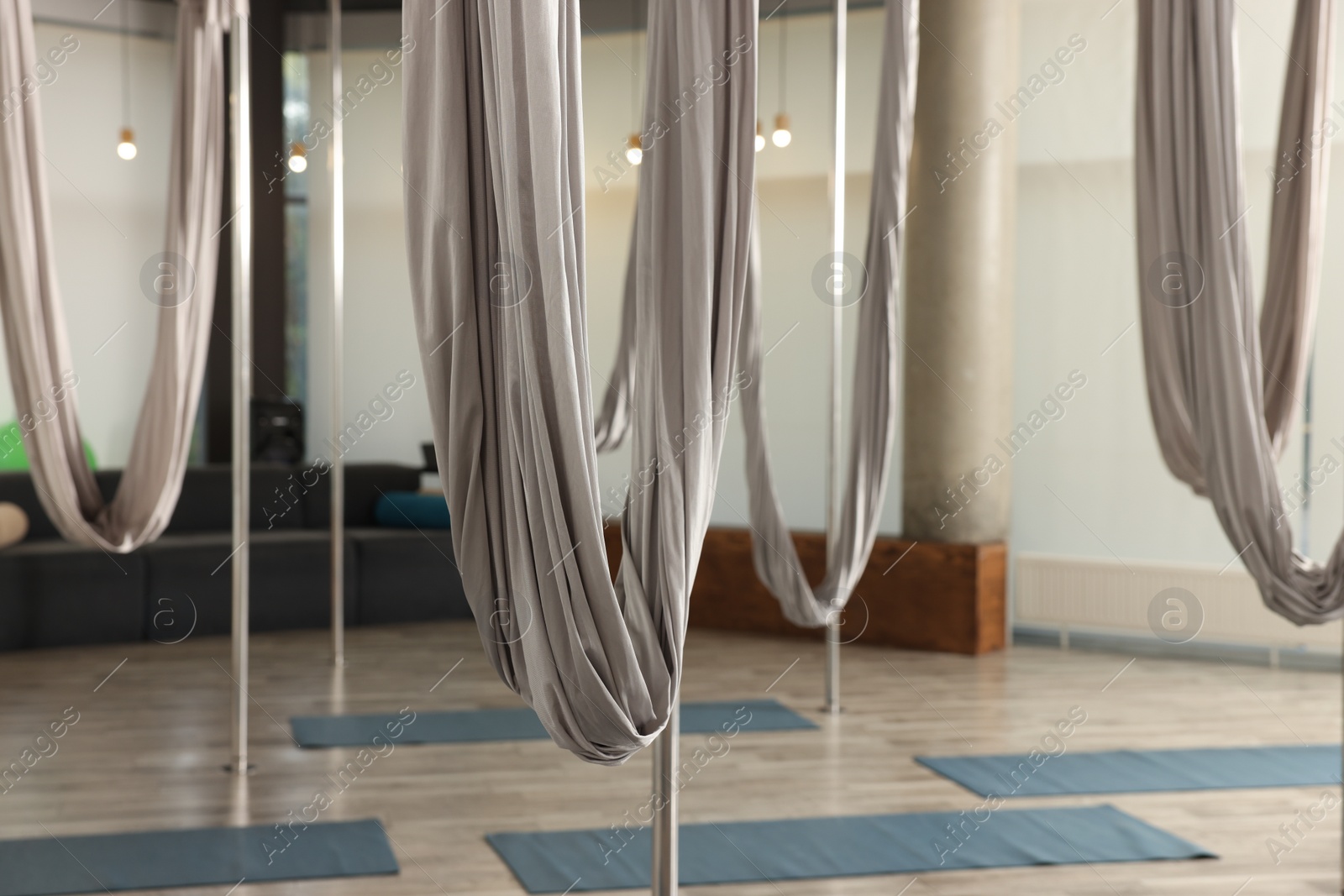 Photo of Many hammocks for fly yoga in studio, space for text