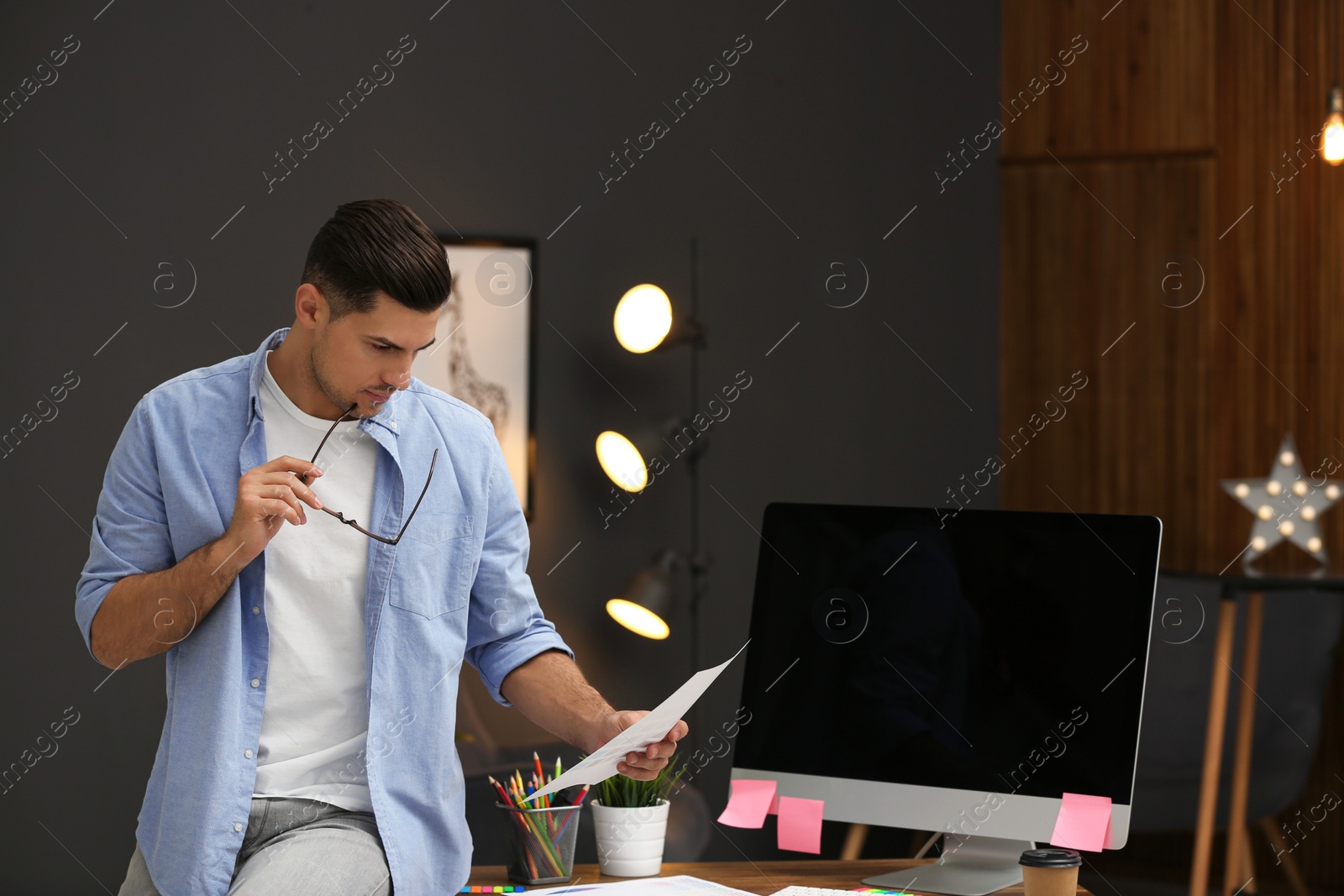 Photo of Male designer working in office. Creative profession
