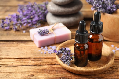 Cosmetic products and lavender flowers on wooden table