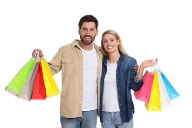 Family shopping. Happy couple with many colorful bags on white background