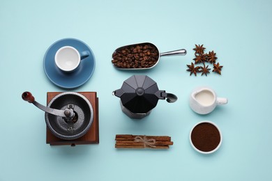 Photo of Flat lay composition with vintage manual coffee grinder and spices on light blue background