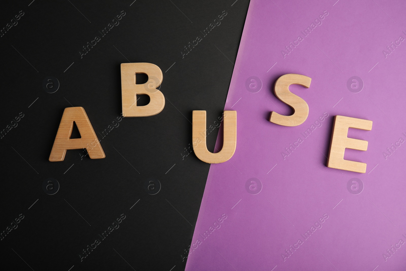 Photo of Word ABUSE on color background, flat lay. Domestic violence awareness
