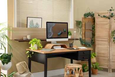 Photo of Light room interior with comfortable workplace near window