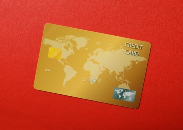 Credit card on red background, top view