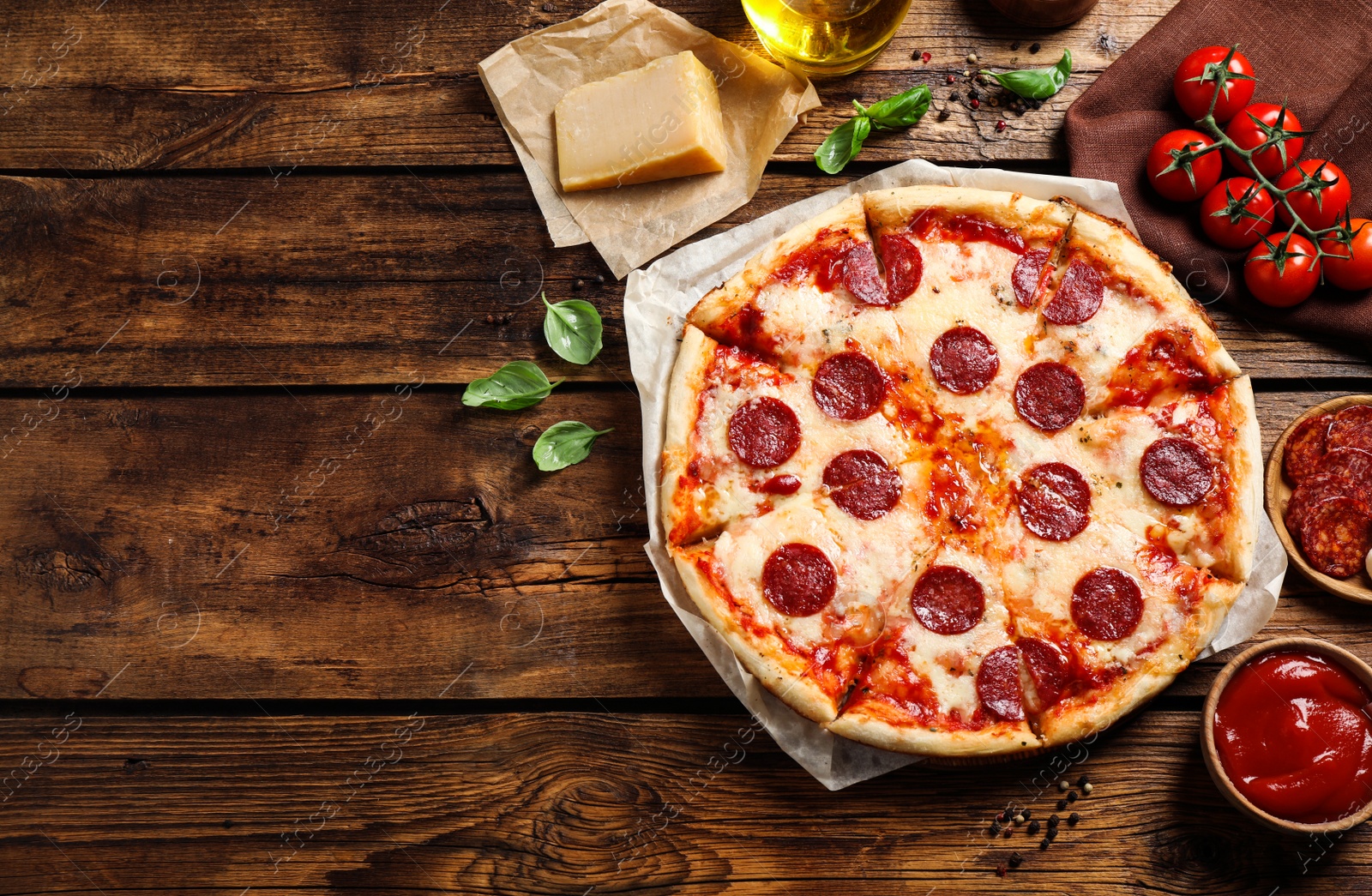 Photo of Flat lay composition with hot pepperoni pizza on wooden table. Space for text