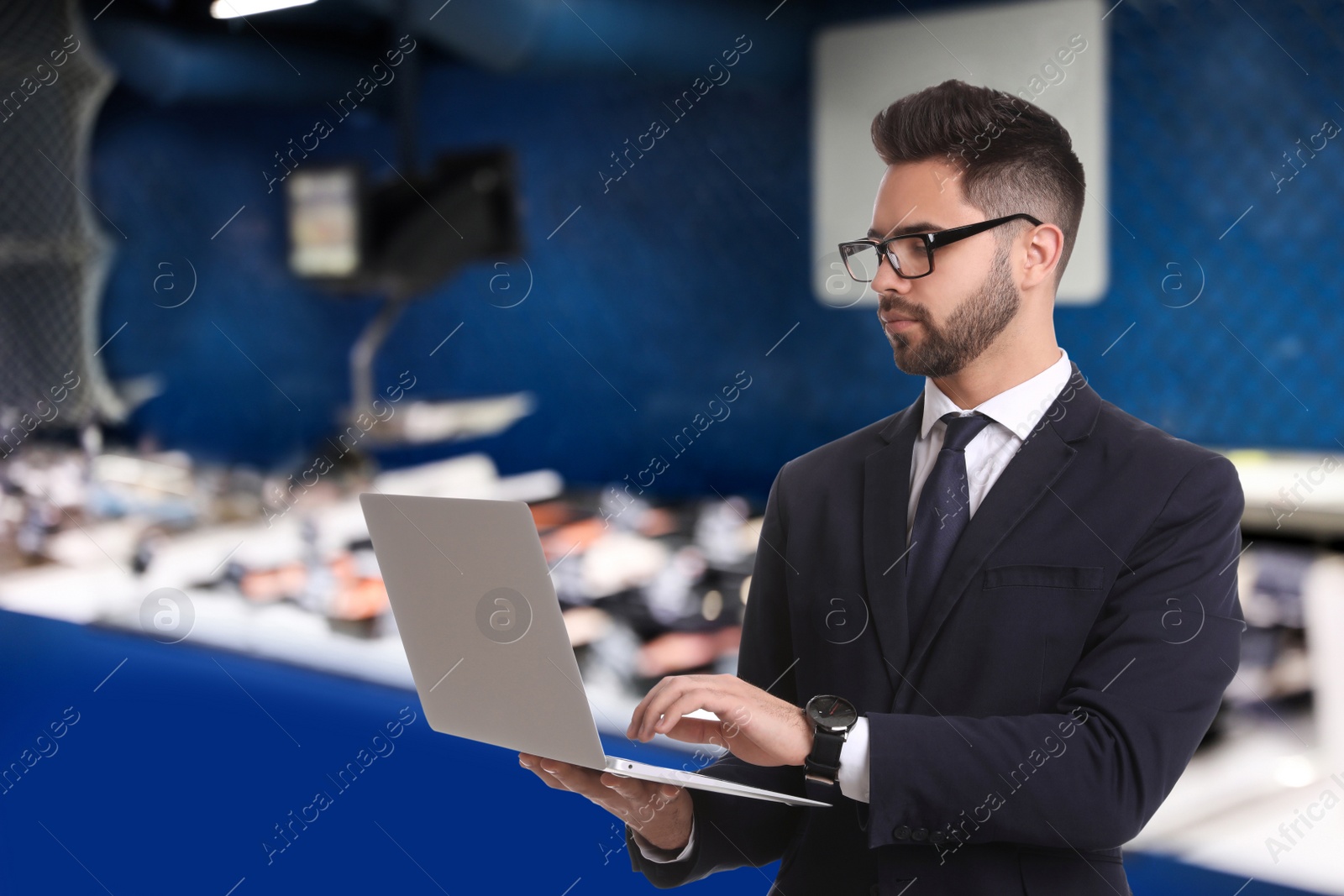 Image of Wholesale and logistics concept. Manager using laptop in store