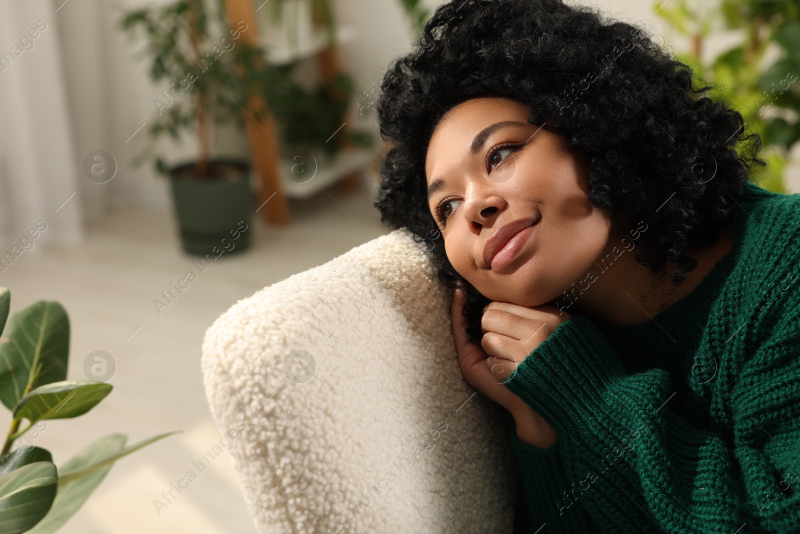 Photo of Woman relaxing near beautiful houseplants at home. Space for text