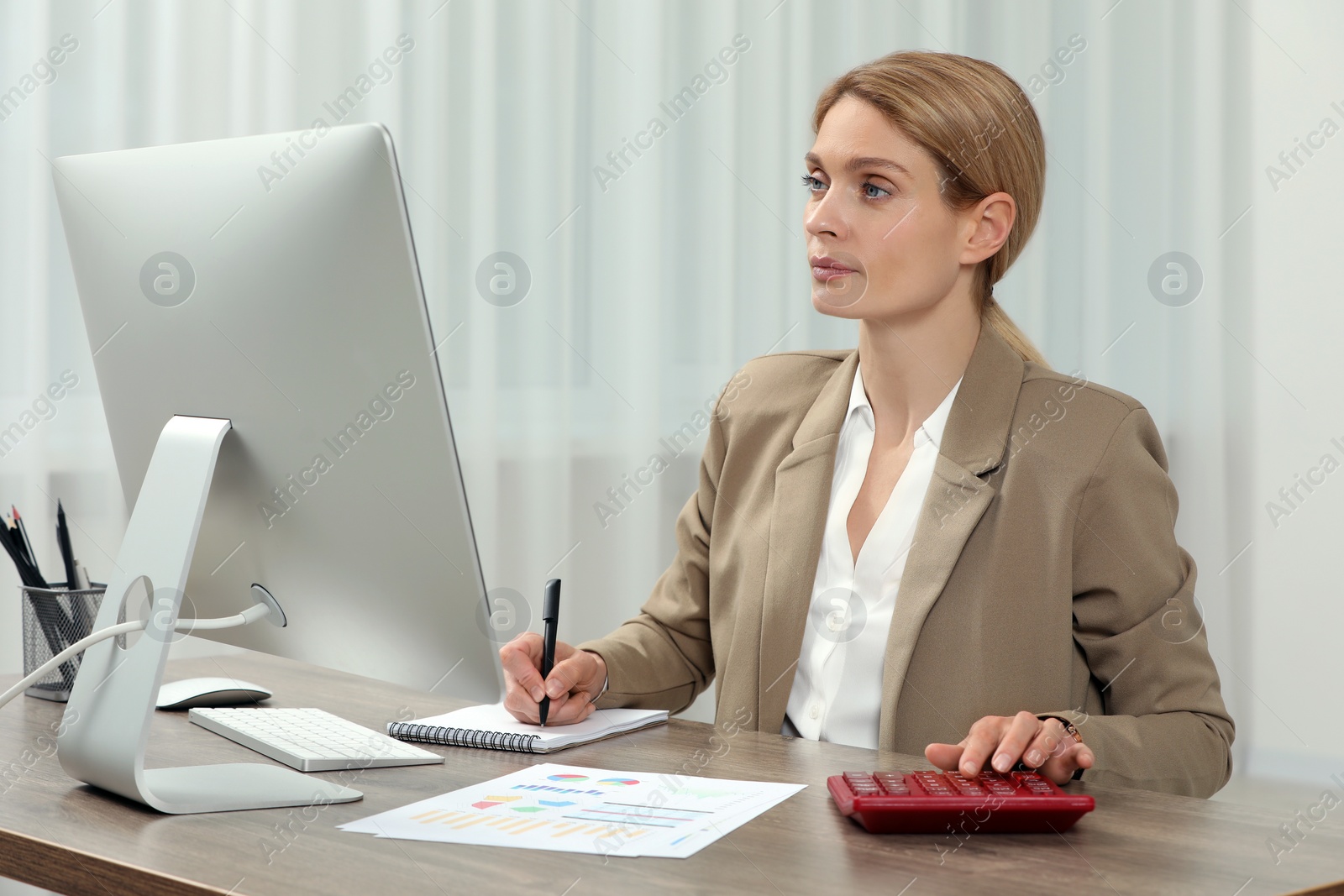 Photo of Professional accountant working at wooden desk in office