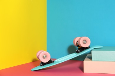 Photo of Turquoise skateboard on color background. Space for text