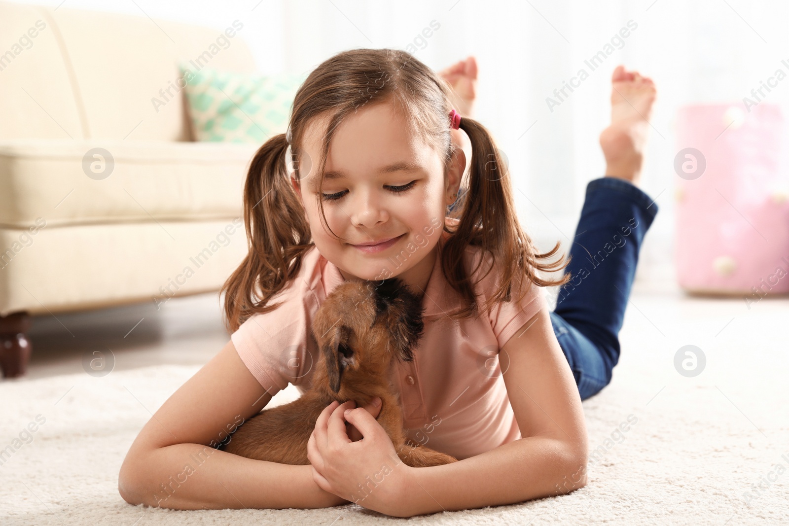 Photo of Portrait of cute girl with funny Brussels Griffon dog at home. Loyal friends