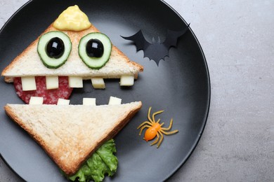 Photo of Cute monster sandwich served on grey table, top view. Halloween party food