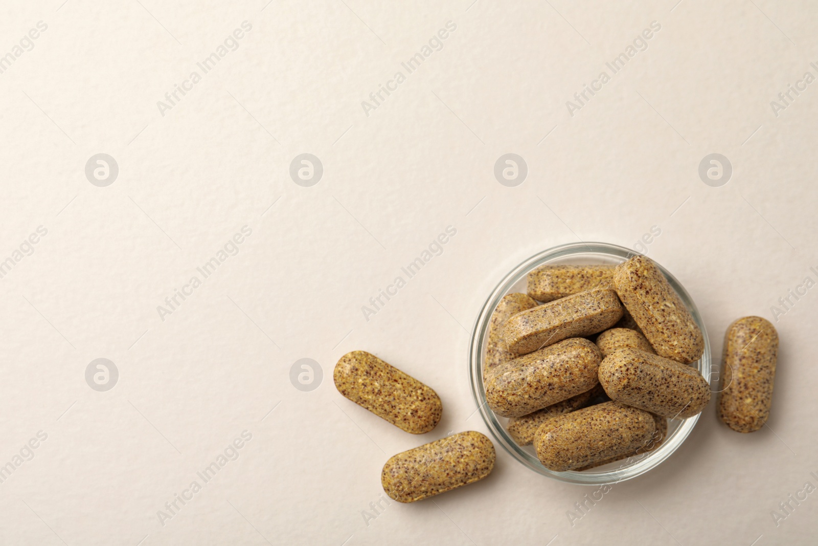 Photo of Dietary supplement pills on white background, flat lay. Space for text