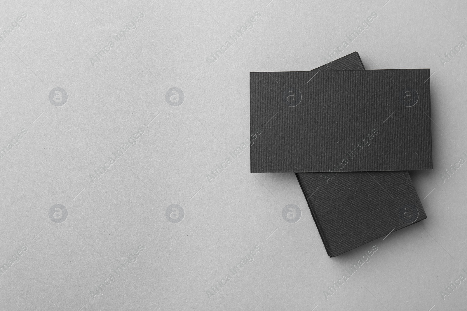 Photo of Blank black business cards on light background, top view. Mockup for design