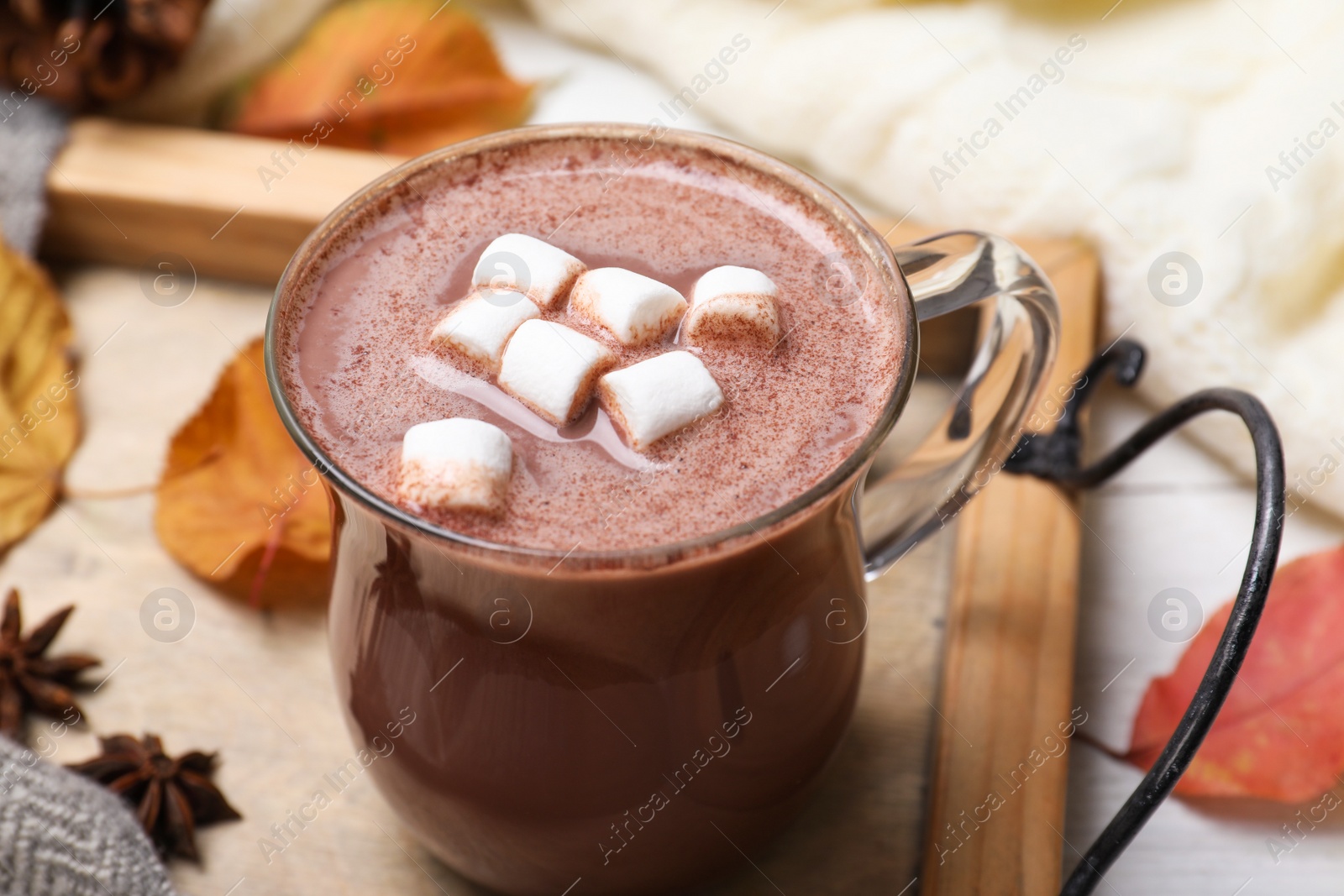 Photo of Cup of hot drink on white table, closeup. Cozy autumn atmosphere