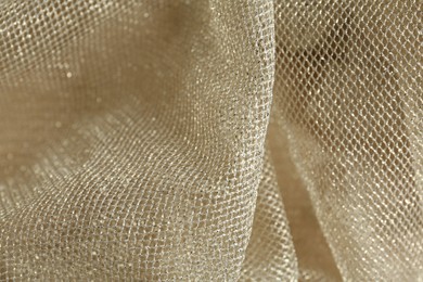 Photo of Texture of golden net fabric as background, closeup