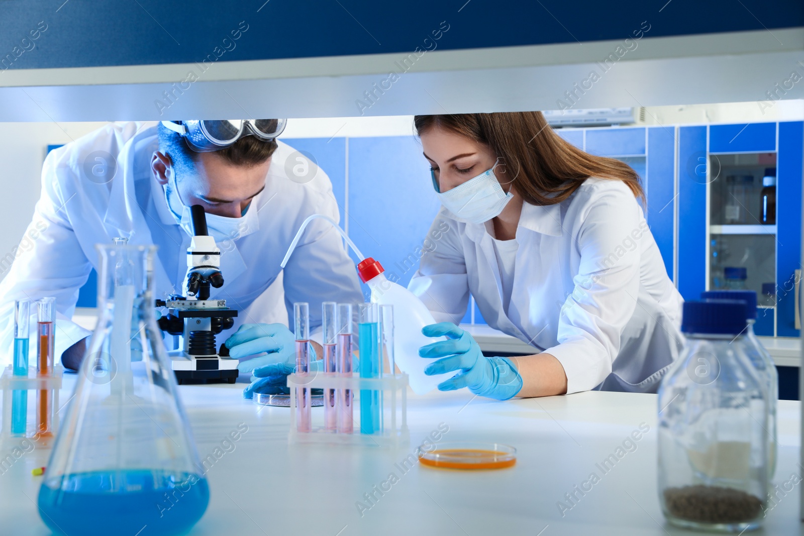 Photo of Scientists doing research and analysis with microscope in laboratory