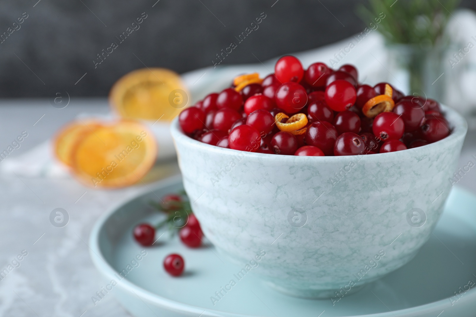 Photo of Fresh ripe cranberries on grey table, closeup. Space for text