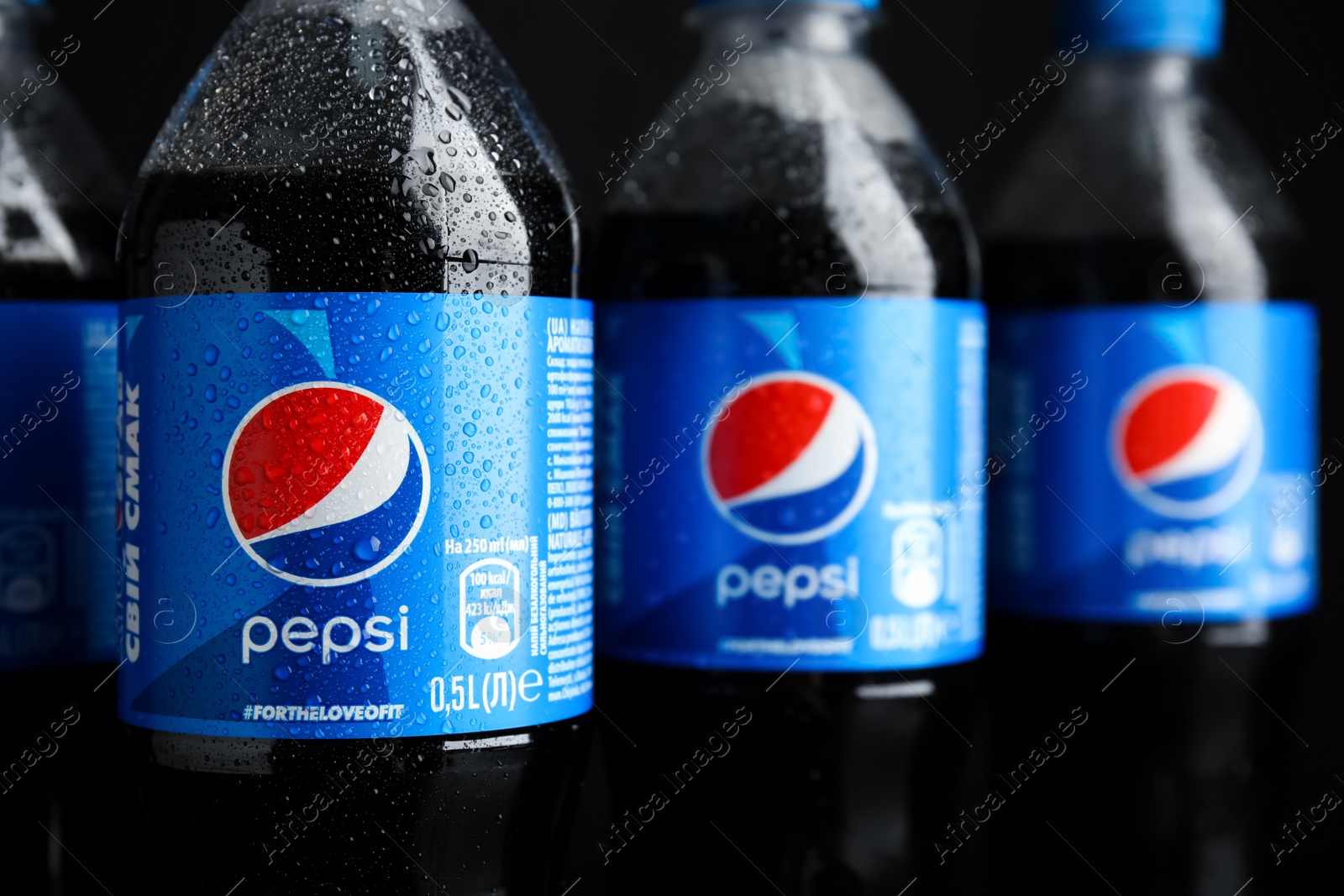 Photo of MYKOLAIV, UKRAINE - FEBRUARY 08, 2021: Plastic bottles of Pepsi with water drops, closeup