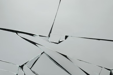 Photo of Shards of broken mirror on dark background, top view