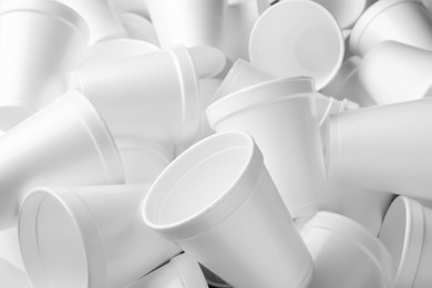 Heap of white styrofoam cups as background, closeup