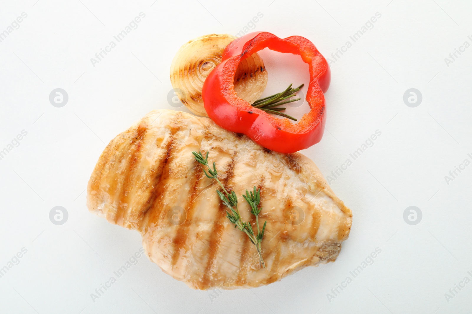 Photo of Delicious grilled meat with herbs and vegetables on white background, top view