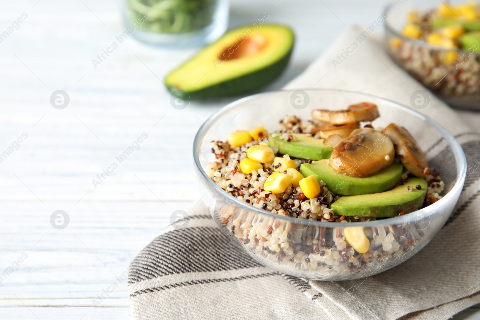 Photo of Healthy quinoa salad with vegetables in bowl on table. Space for text