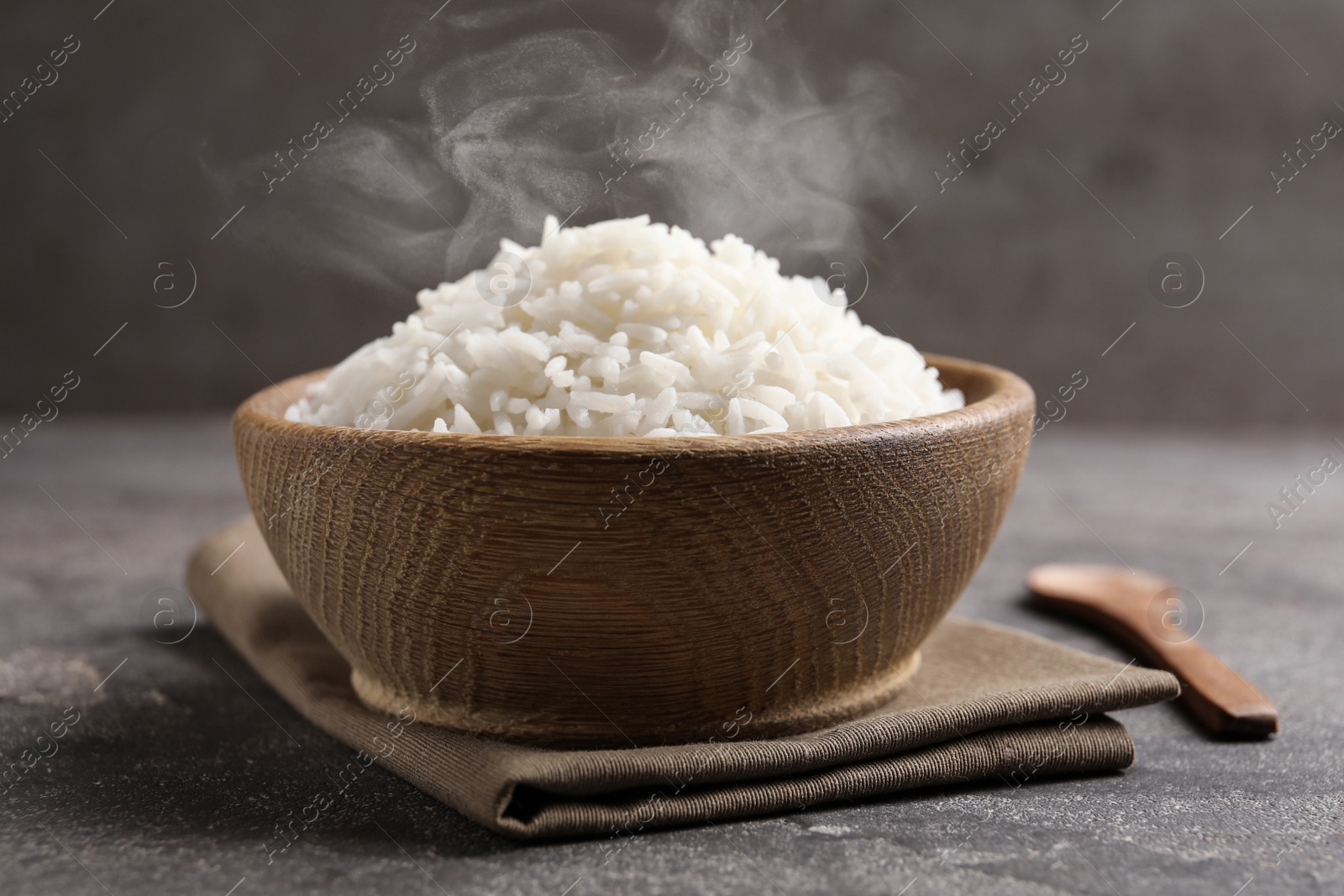 Image of Bowl of tasty cooked rice served on table