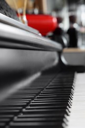 Photo of Black and white grand piano in cafe, closeup