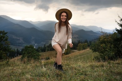 Photo of Young woman enjoying her time in mountains