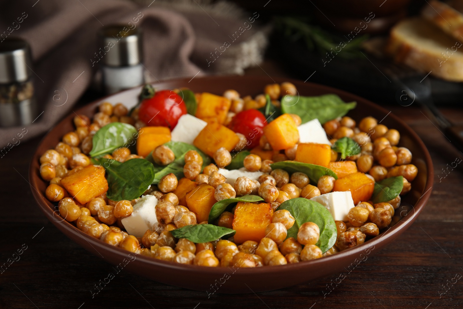 Photo of Delicious fresh chickpea salad on wooden table